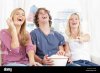 three-friends-eating-popcorn-while-laughing-at-the-show-CY9A32.jpg
